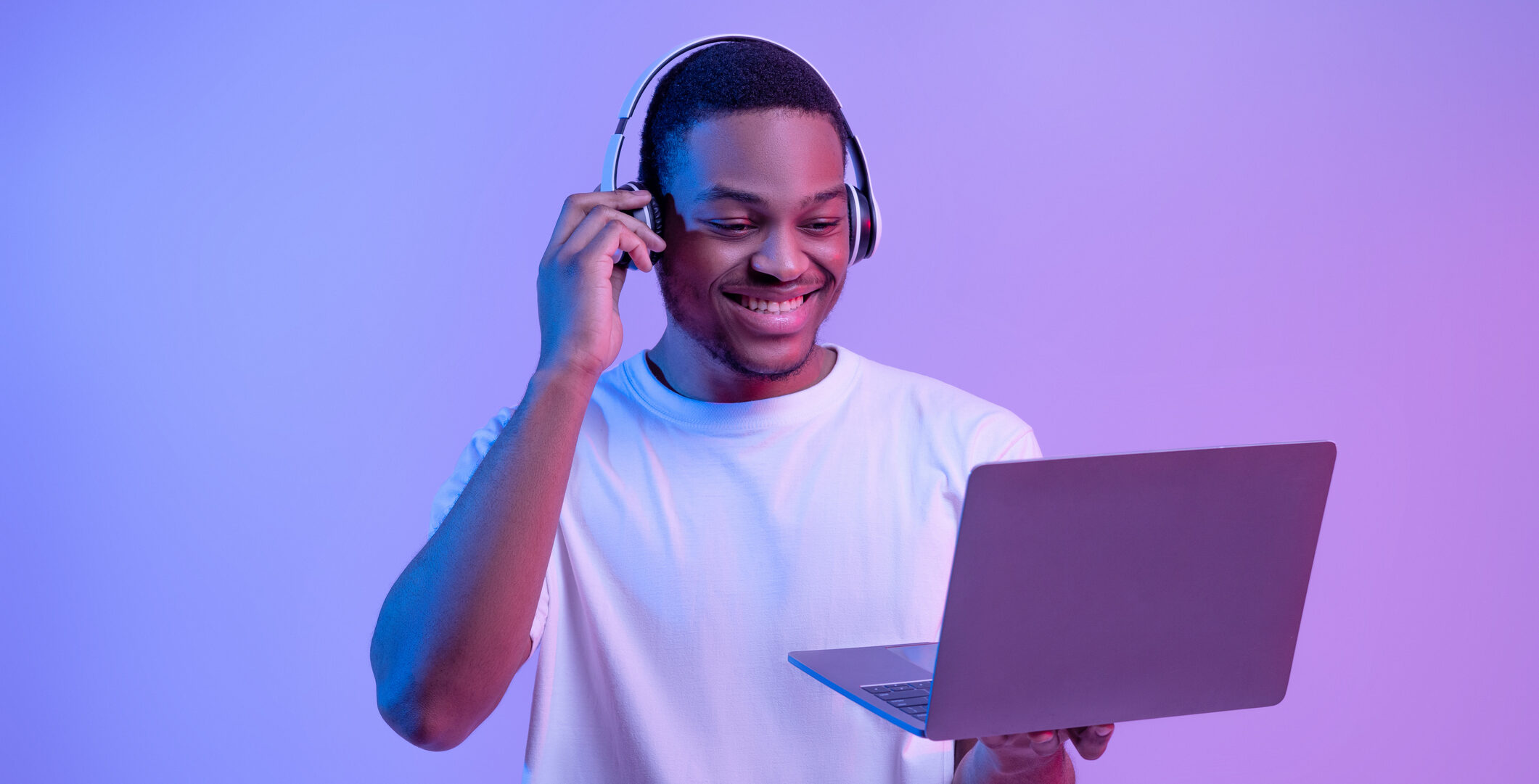 Black Gamer Man In Headset Playing Video Games On Laptop, Neon Lighting